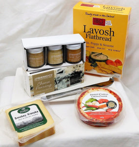 Cheese lover gift with a selection of cheeses, white serving platter, cheese pairing honeys, 180 Degrees lavosh and cheese knife