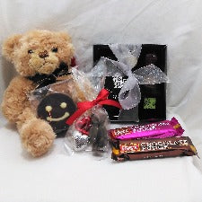 Cheerful teddy bear gift with cuddly Bramble teddy bear, chocolate selection, fudge bard and small chocolates